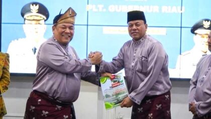 Suhardiman Amby Bupati Kuantan Singingi Menerima data Tunggakan Pajak dari PLT Gubernur Riau SF Hariyanto. Dok. DiskominfoTik Riau
